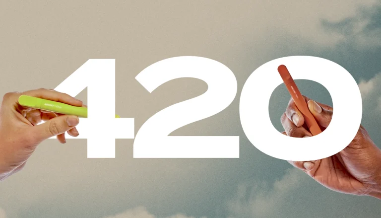 kurvana-420-banner-2025 | Kurvana | Curated for years. Experienced in moments. Two hands holding vape pens with large 420 text against a cloudy sky background.